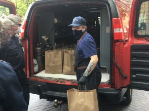 Chef Ryan Loads Meals into a High Associates Van