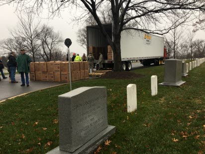Wreathes Across America team members ready Gaylord boxes of wreathes unloaded from High Transit LLC’s truck in Arlington National Cemetery. 
