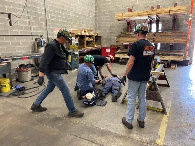 Coworkers performing first aid training