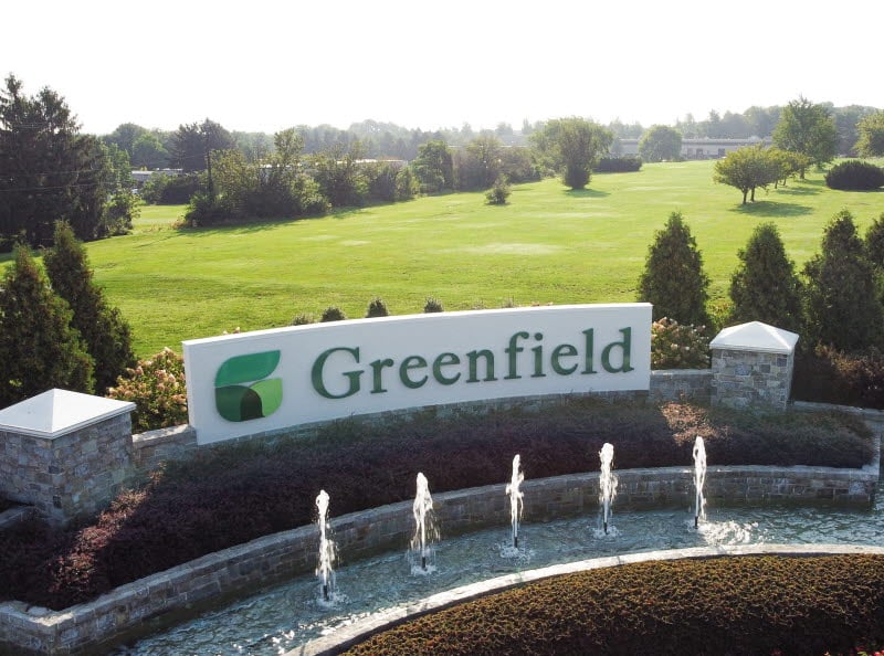 Greenfield monument sign with fountain.